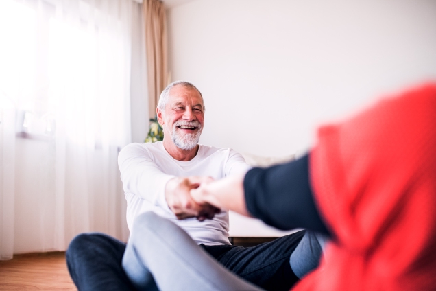 Older Man stretching with partner