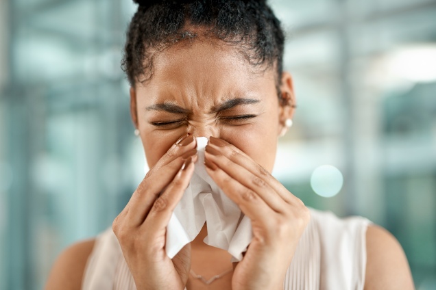 Woman rubbing her nose