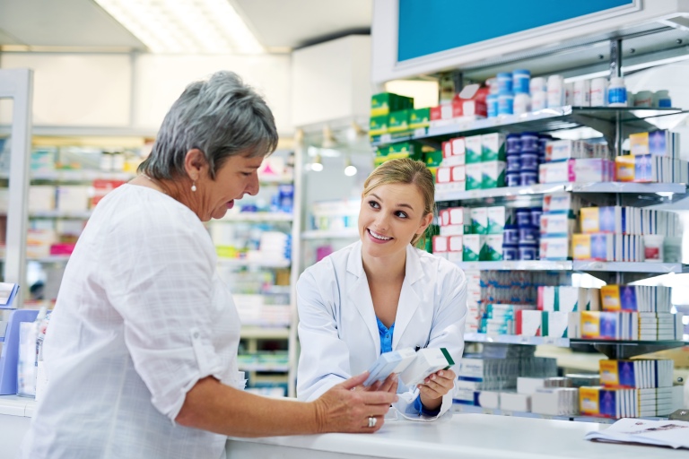 female pharmacist explaining prescription to a female patient