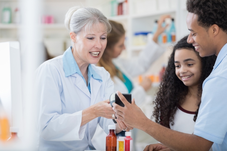 pharmacist explaining to patient and daughter