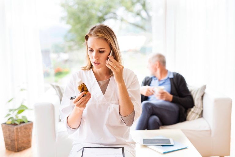 Nurse on the phone reviews prescription