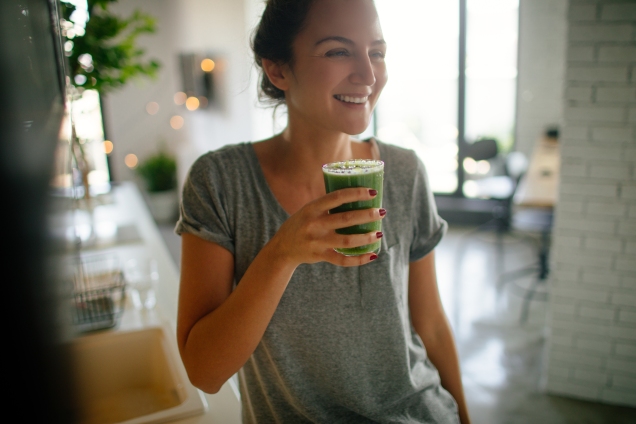 Young woman with green smoothie