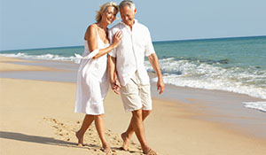 A couple walking on the beach shore