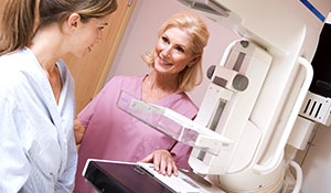 tech giving mammogram