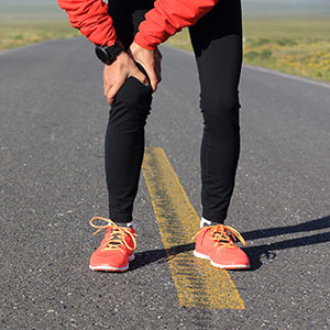 runner holding their knee