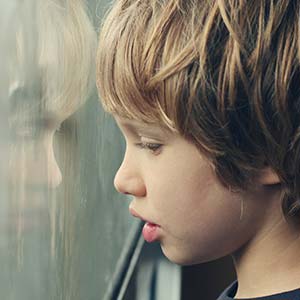 Child looking out window