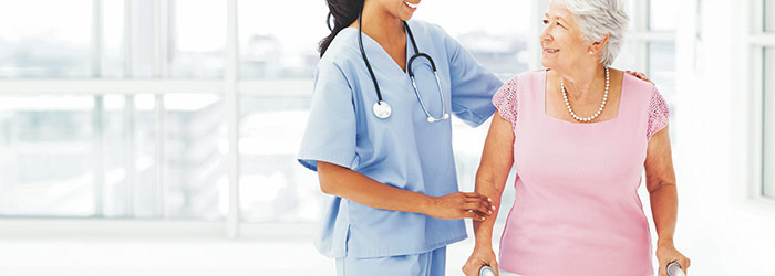 Doctor assisting elderly woman